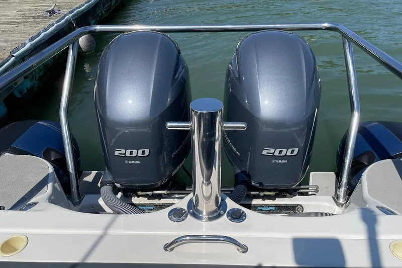 Slide: The Image of Twin Yamaha 200 engines on a 2006 Protector Targa 28 boat at dock. - 16