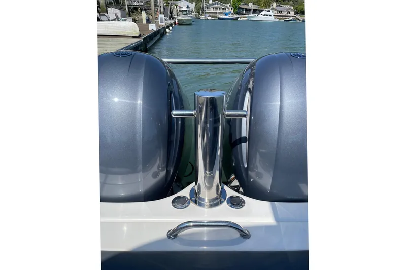 Slide: The Image of 2006 Protector Targa 28 boat with dual engines docked by the water. - 17