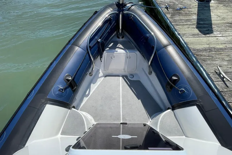 Slide: The Image of 2006 Protector Targa 28 boat bow, docked on calm water. - 19