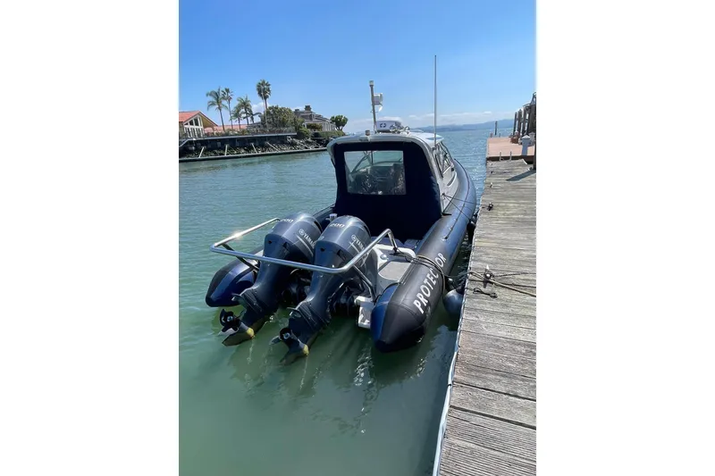 Slide: The Image of 2006 Protector Targa 28 boat docked with dual Yamaha outboard engines. - 2