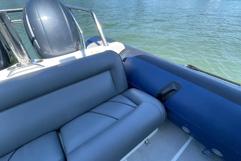 Slide: The Image of 2006 Protector Targa 28 boat interior with cushioned seating and water view. - 29