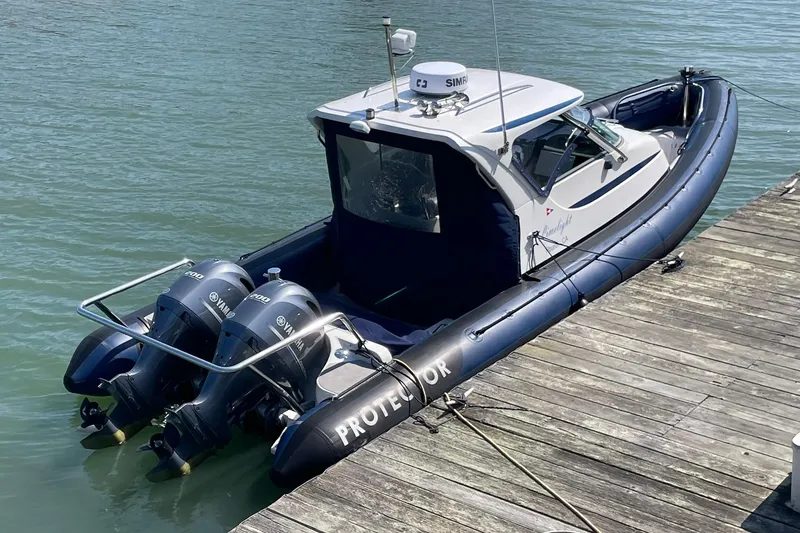 Slide: The Image of 2006 Protector Targa 28 boat docked with dual Yamaha engines. - 3