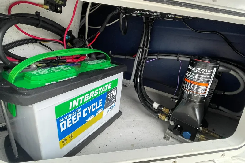 Slide: The Image of Marine battery and steering system inside a 2006 Protector Targa 28 boat. - 32