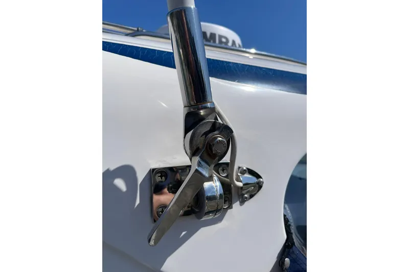 Slide: The Image of Close-up of a 2006 Protector Targa 28 boat's metal latch mechanism against a blue sky. - 36