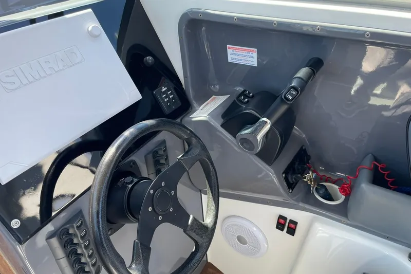 Slide: The Image of 2006 Protector Targa 28 boat dashboard with steering wheel and control panel. - 39