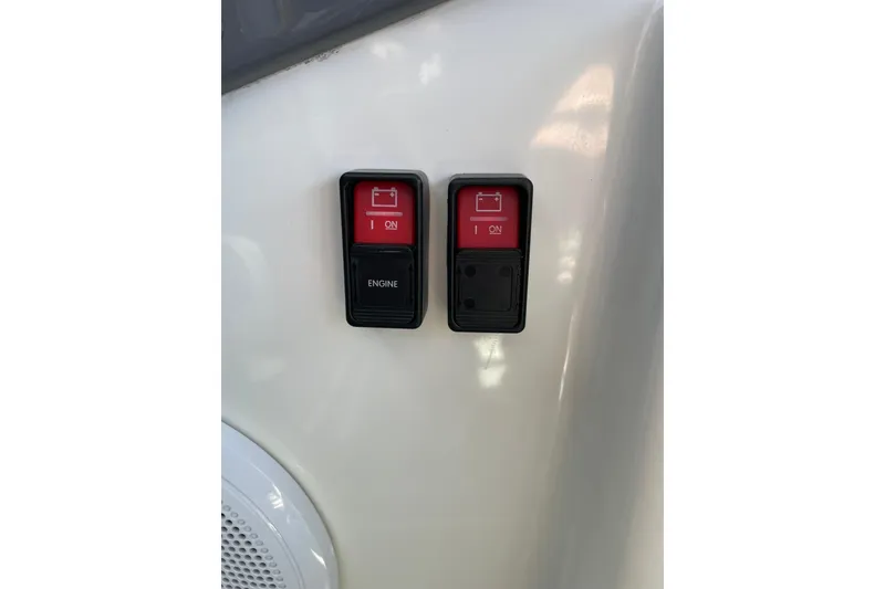 Slide: The Image of Red engine switches on a 2006 Protector Targa 28 boat dashboard. - 40