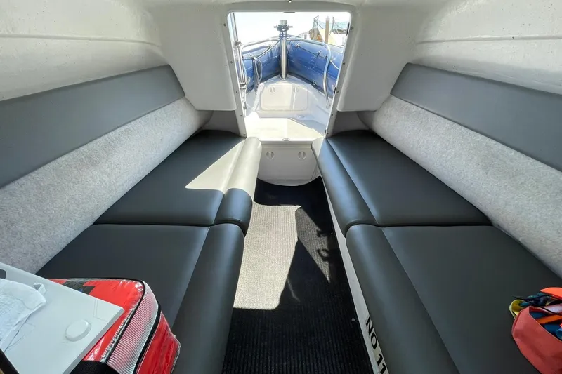 Slide: The Image of Interior of 2006 Protector Targa 28 boat with cushioned seating and carpeted floor. - 46