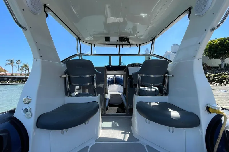 Slide: The Image of Interior view of a 2006 Protector Targa 28 boat with seating and helm. - 48