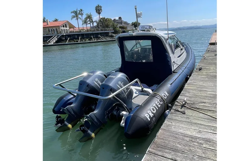 Slide: The Image of 2006 Protector Targa 28 boat docked, featuring dual Yamaha outboard engines. - 5