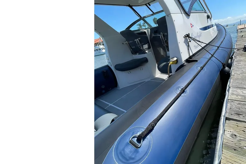 Slide: The Image of 2006 Protector Targa 28 boat docked, showcasing sleek design and spacious interior. - 51