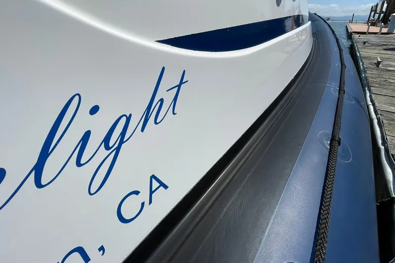 Slide: The Image of Close-up of 2006 Protector Targa 28 boat with blue lettering on the hull. - 52