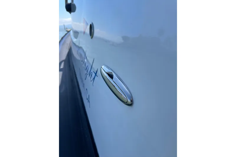 Slide: The Image of Close-up of a 2006 Protector Targa 28 boat's sleek exterior with chrome detailing. - 54