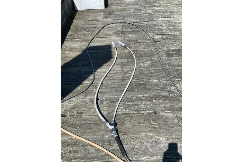 Slide: The Image of Weathered wooden deck with cables, possibly for a 2006 Protector Targa 28 boat. - 61