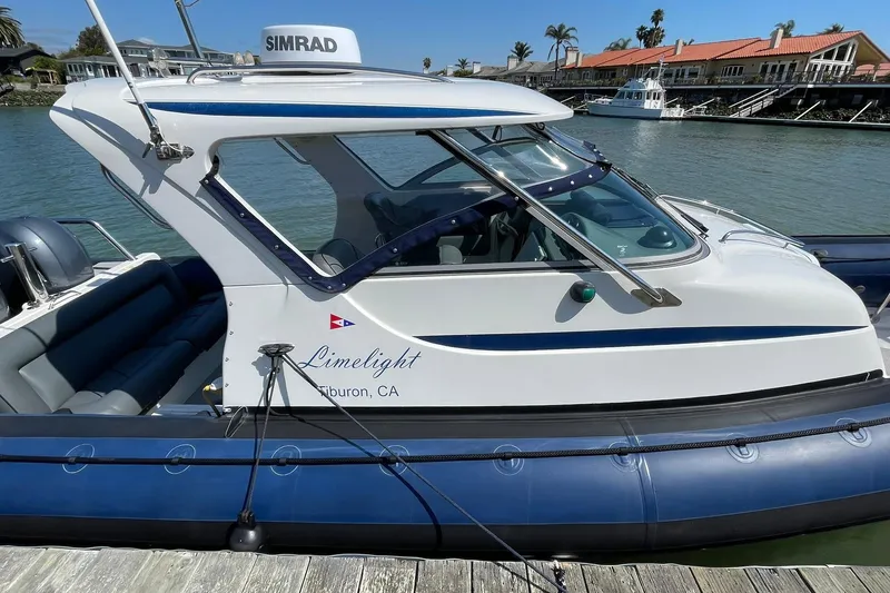Slide: The Image of 2006 Protector Targa 28 boat docked, featuring sleek design and "Limelight" branding, Tiburon, CA. - 7