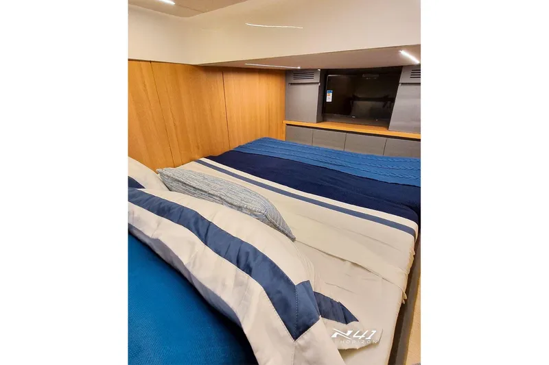 Slide: The Image of Luxurious bedroom interior of 2025 NX Boats NX41 HORIZON with striped bedding. - 16