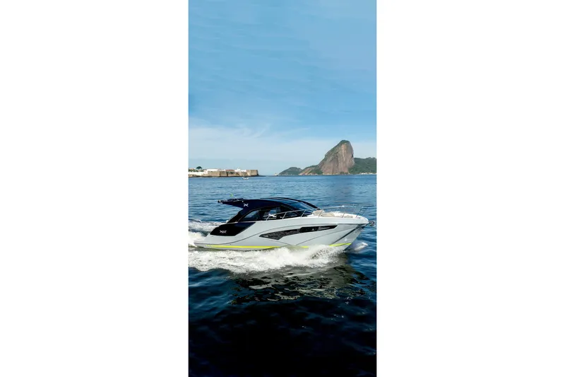 Slide: The Image of 2025 NX Boats NX41 HORIZON cruising on blue waters with scenic mountain backdrop. - 19