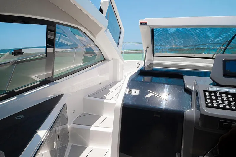 Slide: The Image of Interior view of 2025 NX Boats NX41 HORIZON, showcasing sleek design and modern controls. - 23