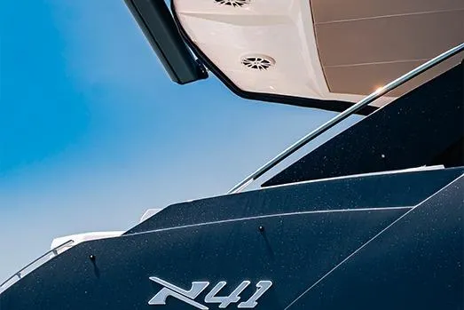 Slide: The Image of 2025 NX Boats NX41 HORIZON yacht, sleek design against a clear blue sky. - 27