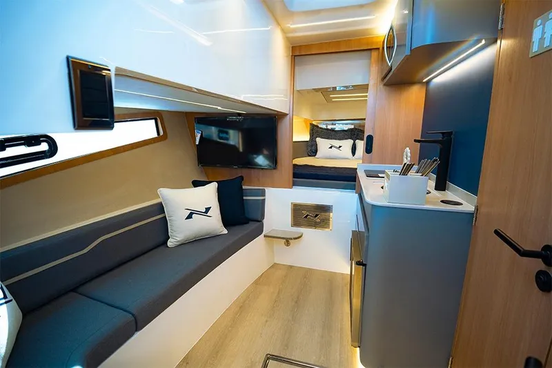 Slide: The Image of Luxurious interior of 2025 NX Boats NX41 HORIZON with modern seating and kitchenette. - 28