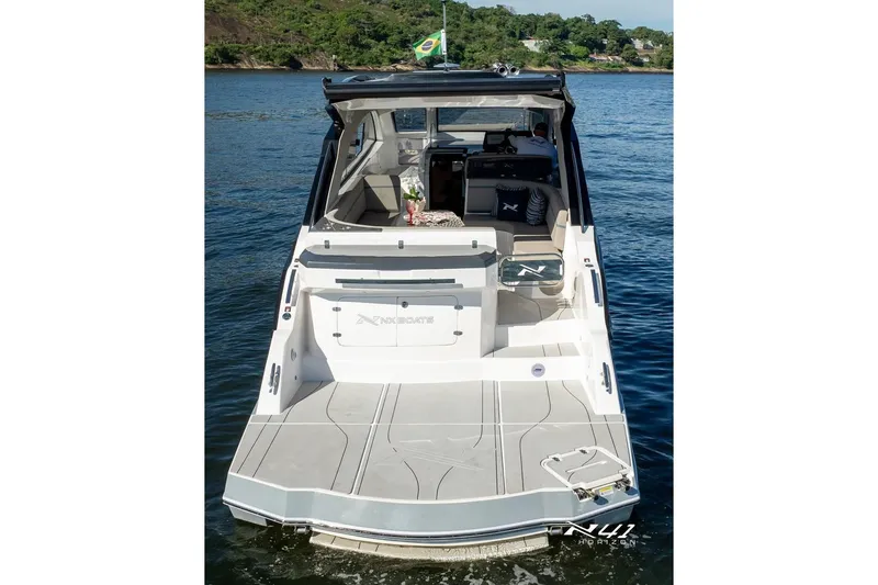 Slide: The Image of 2025 NX Boats NX41 HORIZON on water, rear view with Brazilian flag. - 8