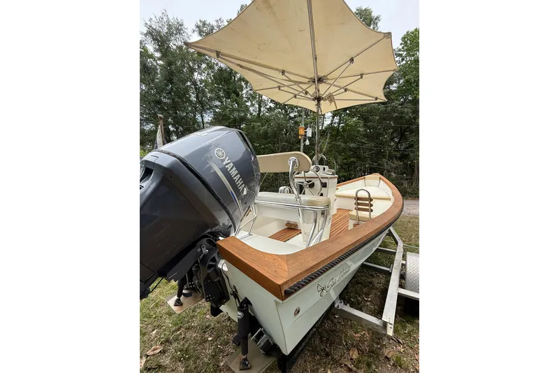 Slide: The Image of 2014 Sea Skiff Caribiana boat with Yamaha motor and canopy, parked on a trailer. - 10