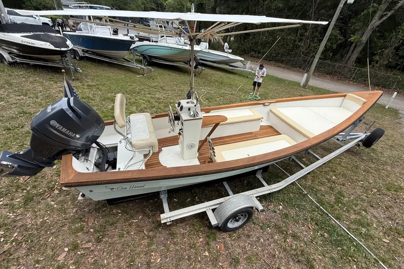 Slide: The Image of 2014 Sea Skiff Caribiana boat on trailer with Yamaha outboard motor, parked on grass. - 11