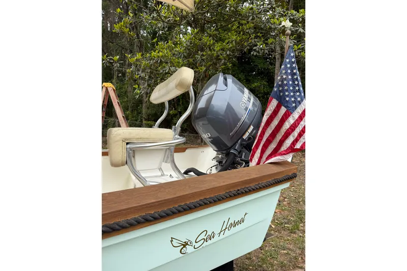Slide: The Image of 2014 Sea Skiff Caribiana boat with Yamaha motor and American flag. - 12
