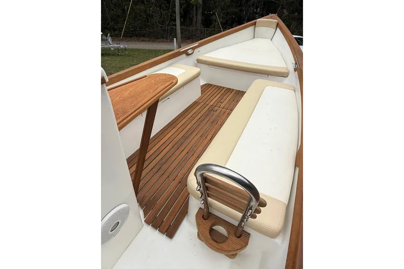 Slide: The Image of 2014 Caribiana Sea Skiff interior with wooden deck and beige seating. - 14