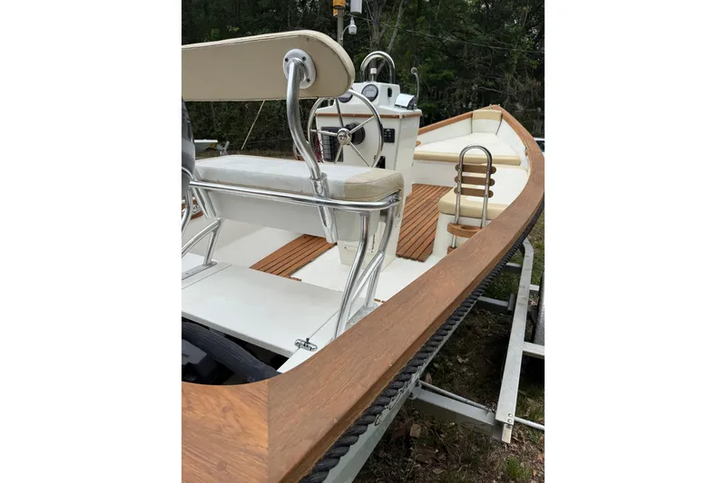 Slide: The Image of 2014 Sea Skiff Caribiana boat with wooden deck and steering wheel on trailer. - 18