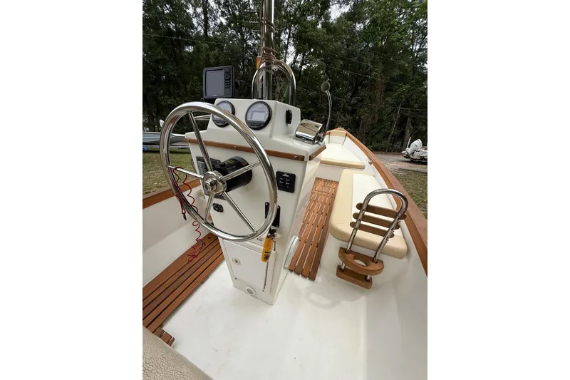 Slide: The Image of 2014 Sea Skiff Caribiana boat interior with steering wheel and control panel. - 5