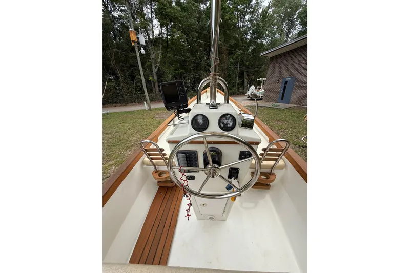 Slide: The Image of 2014 Sea Skiff Caribiana boat helm with steering wheel and navigation equipment. - 8