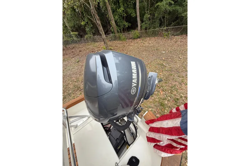 Slide: The Image of 2014 Sea Skiff Caribiana with Yamaha outboard motor and American flag. - 9
