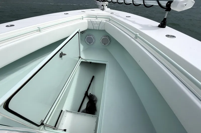 Slide: The Image of 2019 Contender 30 ST boat with open storage compartment and fishing gear. - 13