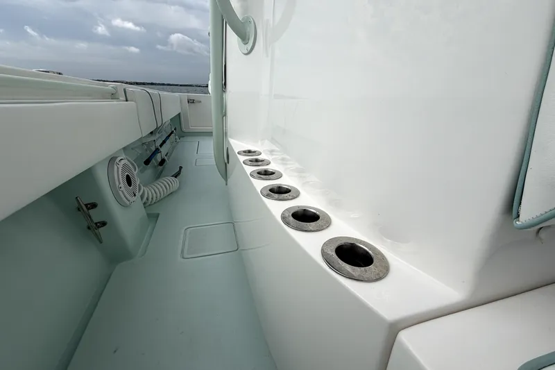 Slide: The Image of 2019 Contender 30 ST boat interior with rod holders and storage compartments. - 17