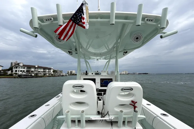 Slide: The Image of 2019 Contender 30 ST boat on water, featuring dual seats and American flag. - 28