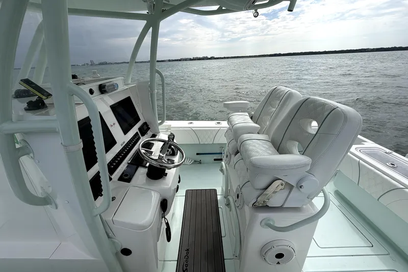 Slide: The Image of 2019 Contender 30 ST boat interior with modern helm and plush seating on open water. - 31