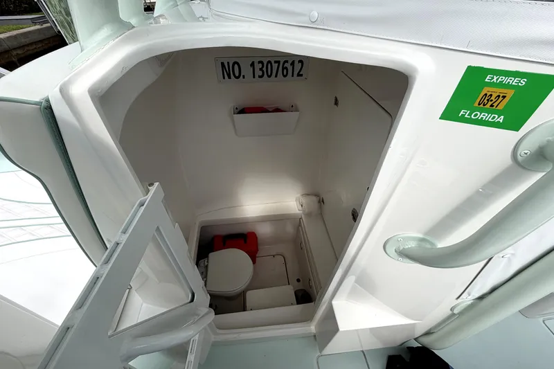 Slide: The Image of 2019 Contender 30 ST boat interior with compact marine toilet and storage. - 40