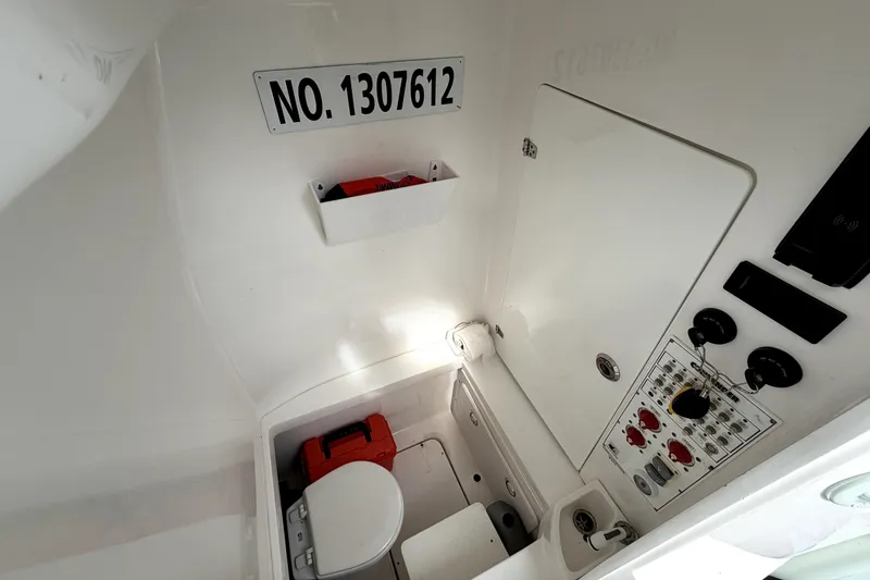 Slide: The Image of 2019 Contender 30 ST boat interior with control panel and storage area. - 41