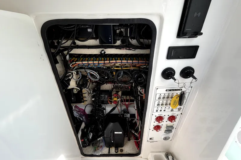 Slide: The Image of Electrical panel of a 2019 Contender 30 ST boat, showcasing wiring and controls. - 42