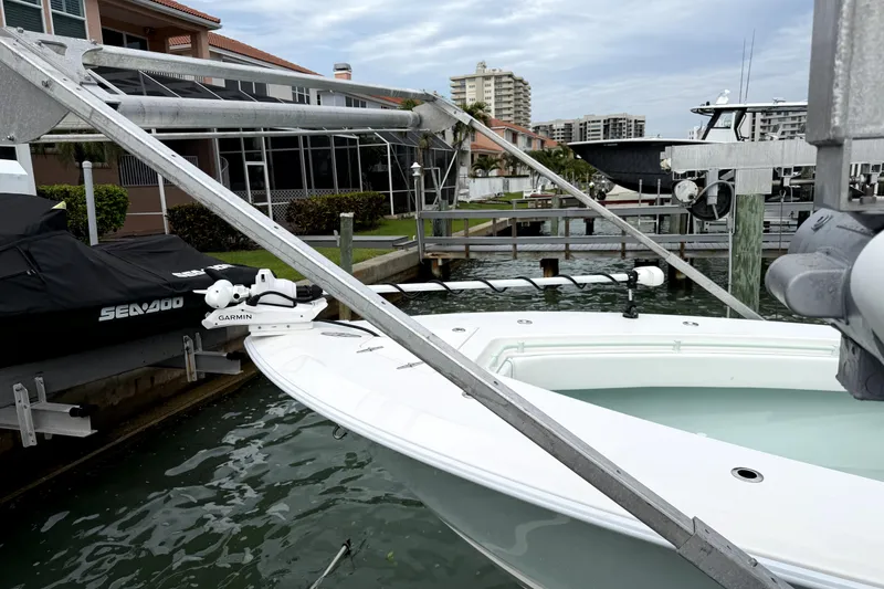 Slide: The Image of 2019 Contender 30 ST boat docked with Garmin equipment, near waterfront homes. - 43