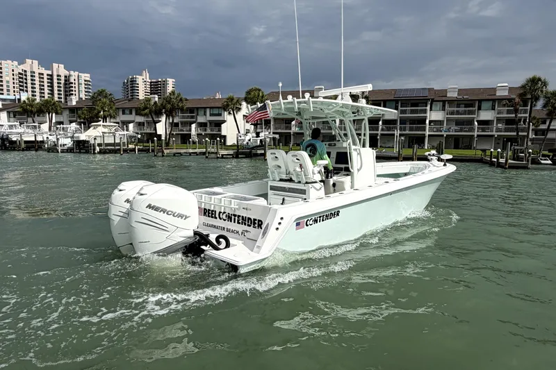 Slide: The Image of 2019 Contender 30 ST boat cruising near Clearwater Beach, FL, with twin Mercury engines. - 6