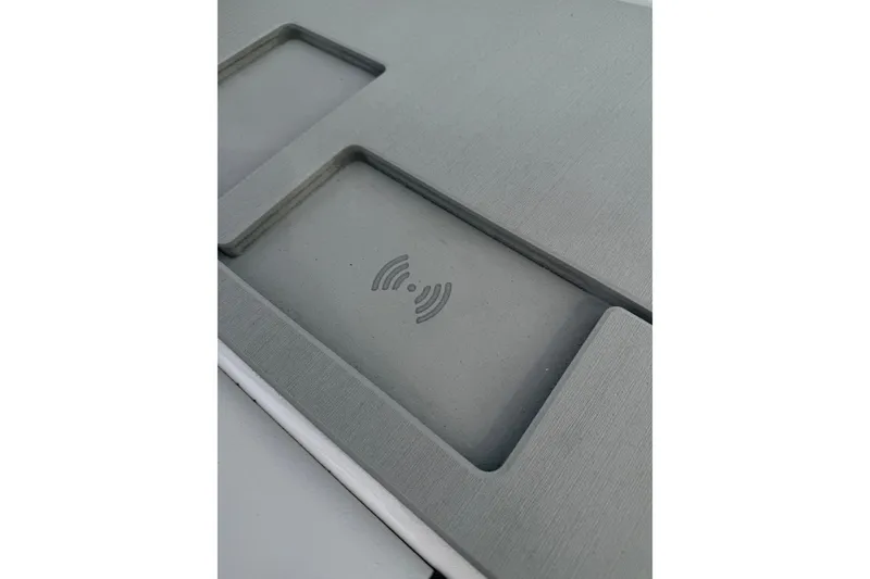 Slide: The Image of 2026 Yamaha Boats AR220 wireless charging pad on sleek gray surface. - 11