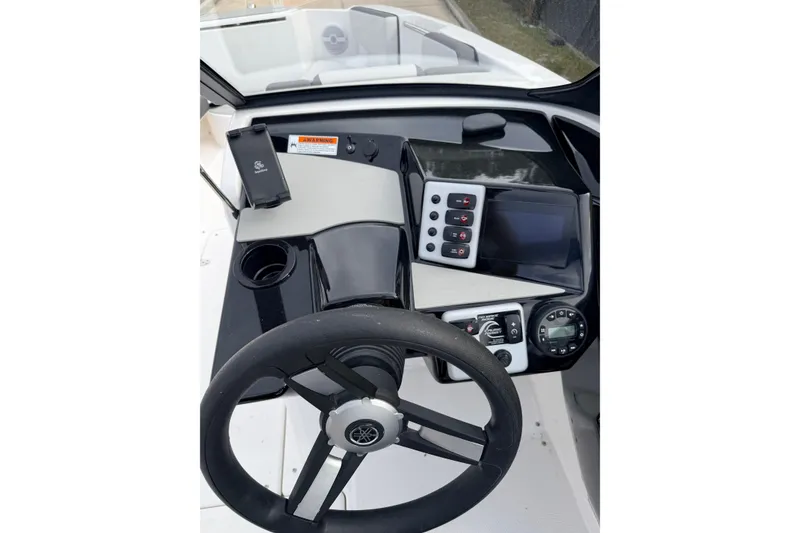 Slide: The Image of 2026 Yamaha Boats AR220 dashboard with steering wheel, controls, and display screen. - 12