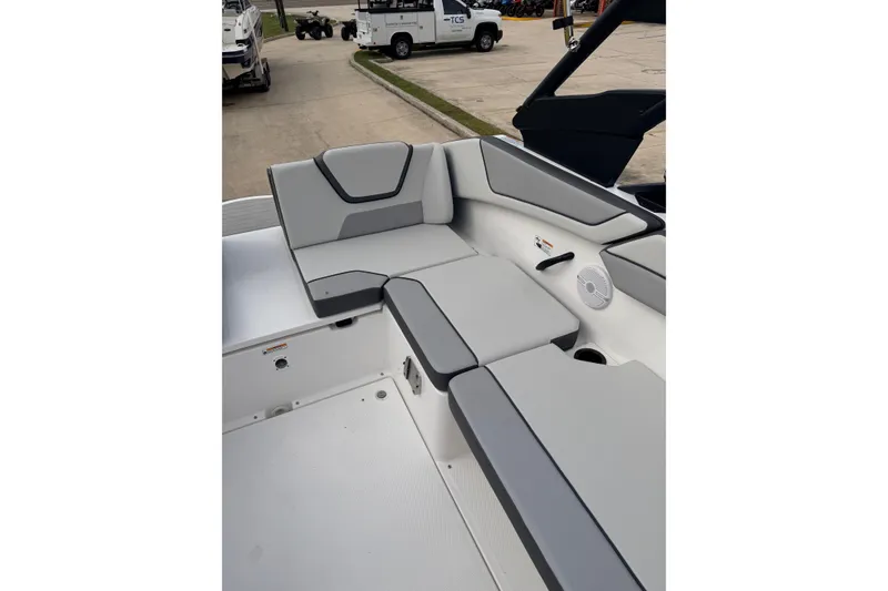 Slide: The Image of 2026 Yamaha Boats AR220 interior seating with gray upholstery and speaker detail. - 7