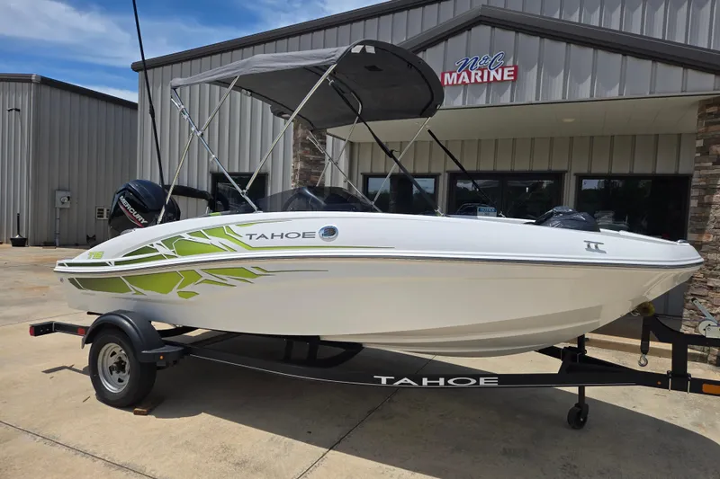 The Image of 2022 Tahoe T16 boat on trailer outside marine dealership. - 1