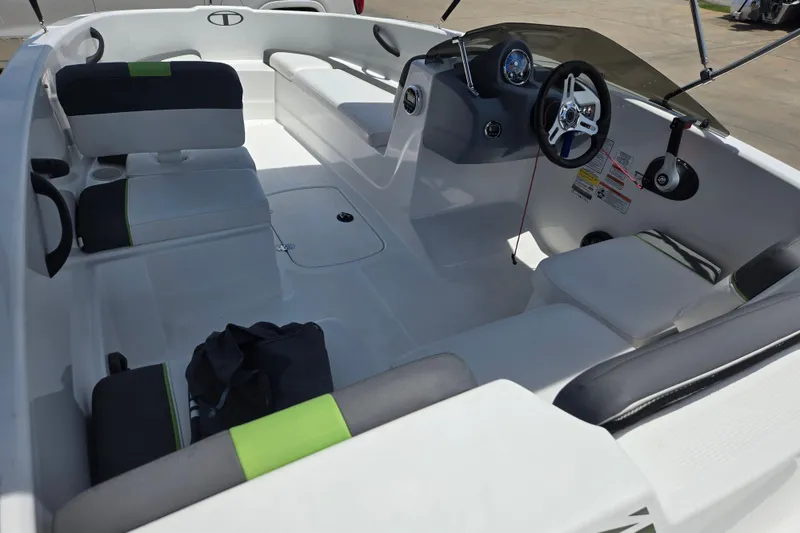 Slide: The Image of 2022 Tahoe T16 boat interior with seating, steering wheel, and dashboard. - 10