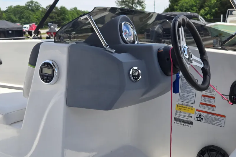 Slide: The Image of 2022 Tahoe T16 boat dashboard with steering wheel and control panel. - 12