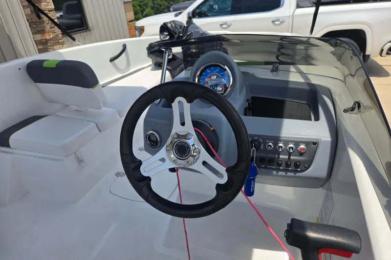 Slide: The Image of 2022 Tahoe T16 boat interior with steering wheel and control panel. - 14