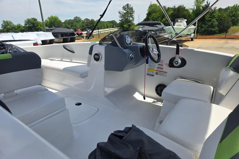 Slide: The Image of Interior view of a 2022 Tahoe T16 boat, featuring seating and steering console. - 17