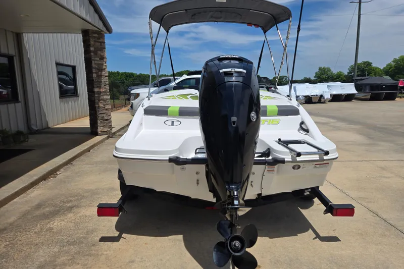 Slide: The Image of 2022 Tahoe T16 boat with outboard motor, parked outdoors on a sunny day. - 4